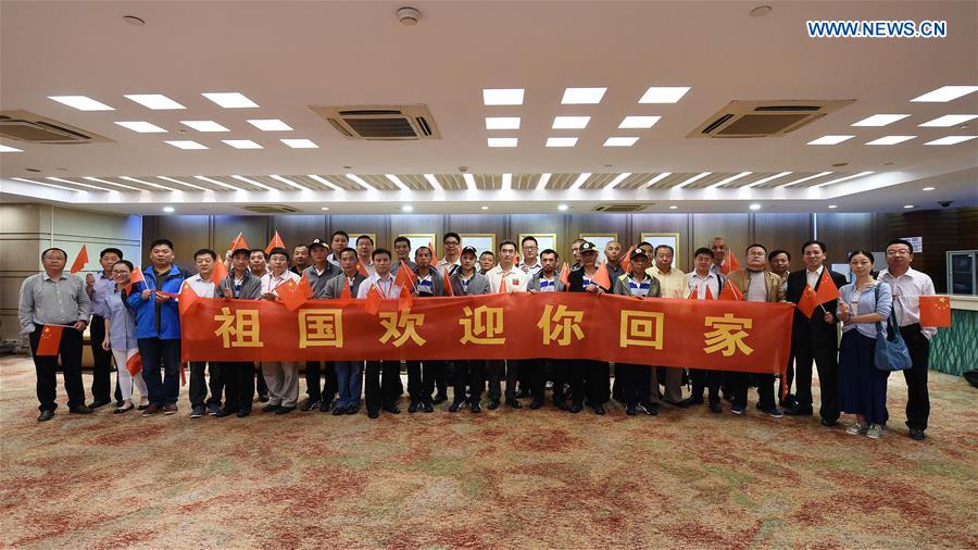 Rescued Chinese people held captive by Somali pirates for years are welcomed upon their arrival at Baiyun International Airport in Guangzhou, south China