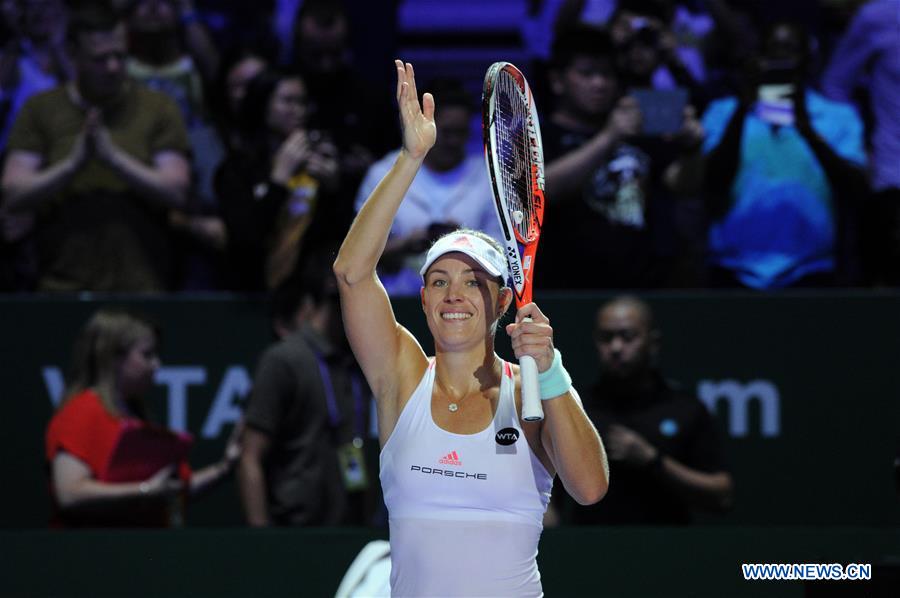 Angelique Kerber of Germany competes during the WTA Finals round robin match against Simona Halep of Romania at Singapore Indoor Stadium, Oct. 25, 2016. Angelique Kerber won 2-0. (Xinhua/Then Chih Wey)