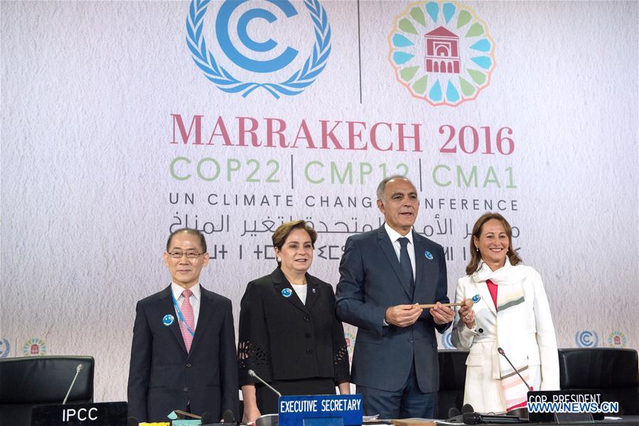 COP21 president Segolene Royal (1st R) hands over the presidency to Morocco