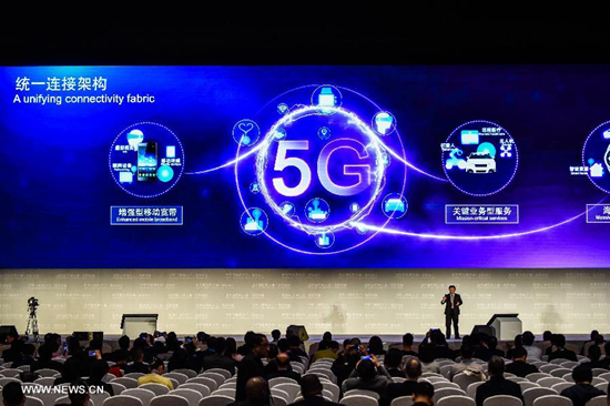 A representative of Qualcomm introduces 5G technology during a release ceremony of world leading internet scientific and technological achievements at the 3rd World Internet Conference in Wuzhen, east China