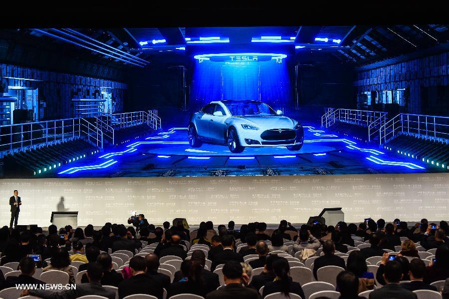 A representative of Tesla introduces an automated assistance driving system during a release ceremony of world leading internet scientific and technological achievements at the 3rd World Internet Conference in Wuzhen, east China