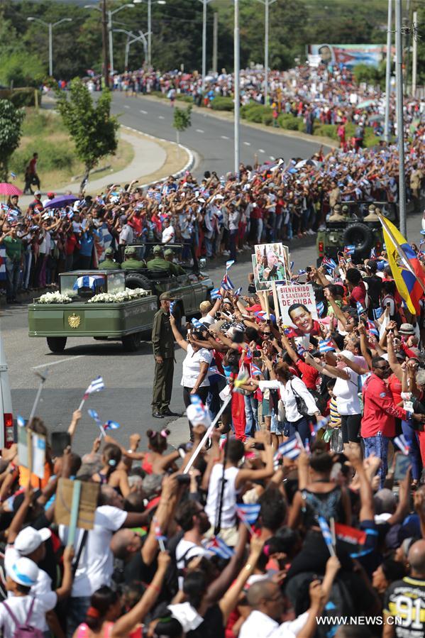 People greet the caravan carrying the ashes of Cuban revolutionary leader Fidel Castro upon its arrival in Santiago de Cuba, southeastern Cuba, on Dec. 3, 2016. As the caravan carrying the ashes of Fidel Castro reached its final destination in Santiago De Cuba, hundreds of thousands of Cubans had come together over the last four days to bid farewell to the revolution leader. Fidel Castro passed away on Nov. 25 at the age of 90. (Xinhua/David de la Paz)