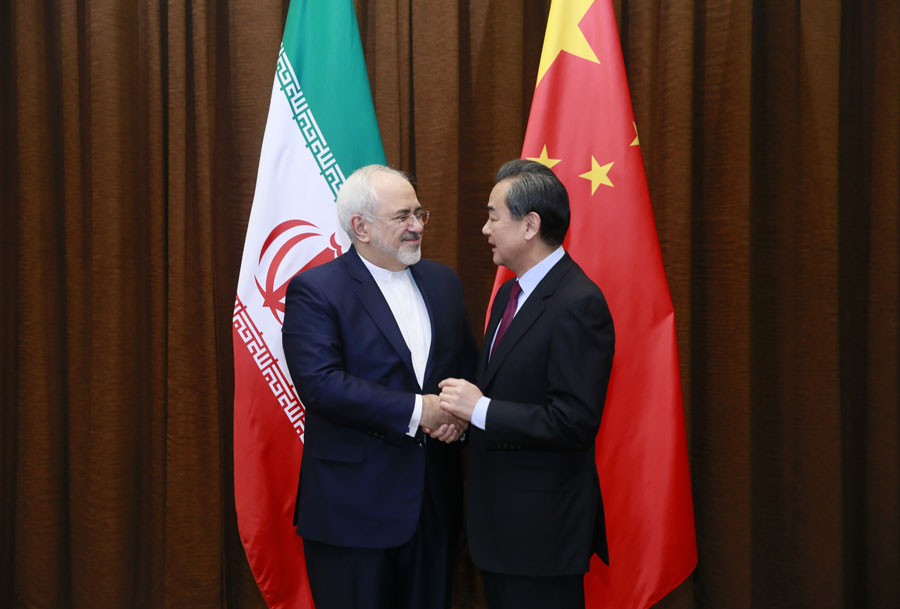 Chinese Foreign Minister Wang Yi (R) shakes hands with his Iranian counterpart Mohammad Javad Zarif in Beijing, capital of China, Dec. 5, 2016. Wang and Zarif co-chaired the first annual foreign ministers