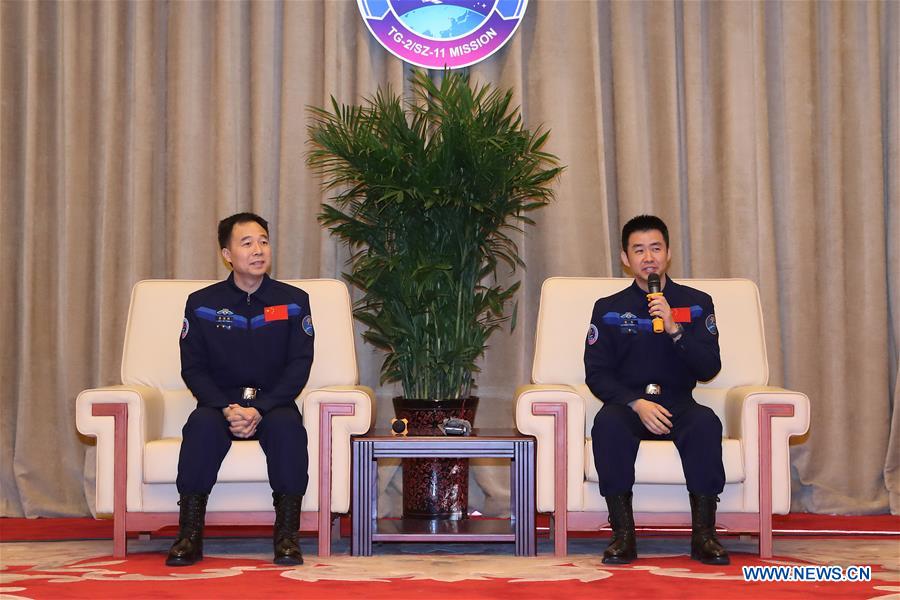 Chinese astronaut Chen Dong (R) answers questions during a press conference in Beijing, capital of China, Dec. 7, 2016. The two astronauts Jing Haipeng and Chen Dong who manned China