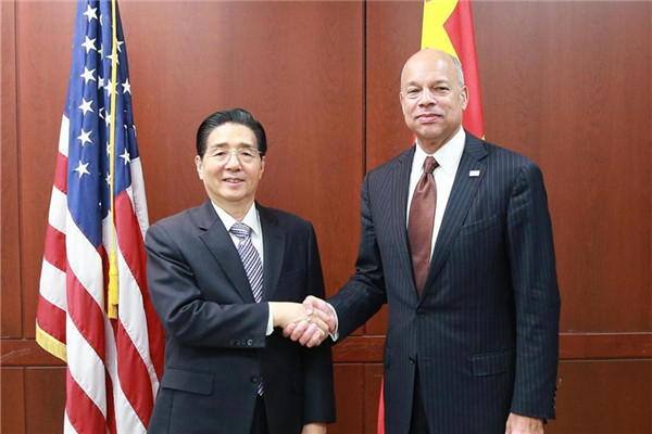 Chinese State Councilor and Minister of Public Security Guo Shengkun (L) shakes hands with U.S. Secretary of Homeland Security Jeh Johnson in Washington, the United States, on Dec. 7, 2016.