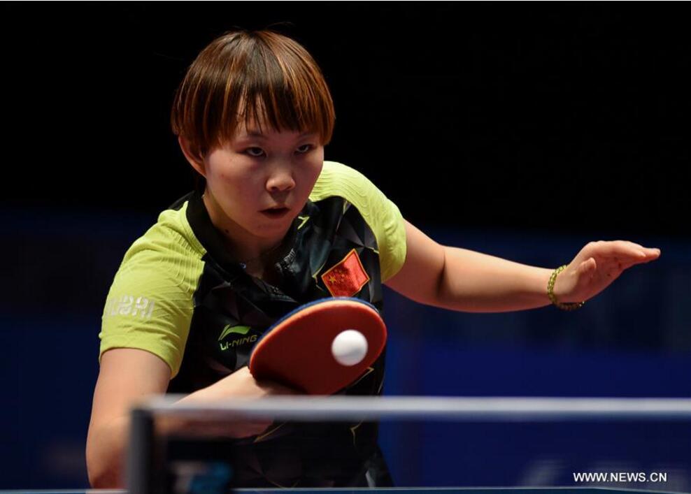 Zhu Yuling of China returns a shot to Sato Hitomi of Japan during the women