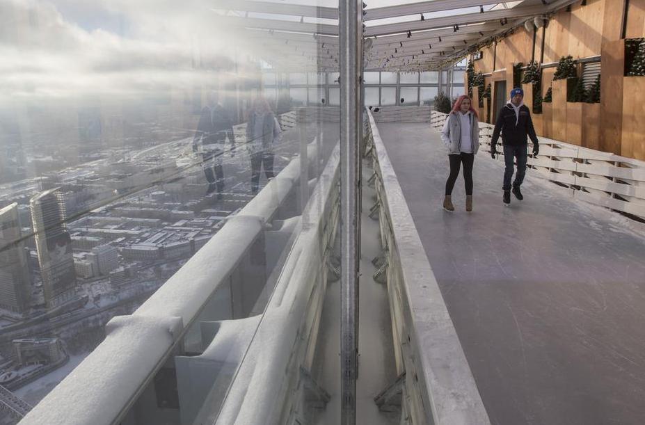 Visitors skate on the BMW Ice Rink 354 located on the 86th storey of the Moscow City OKO Tower. 