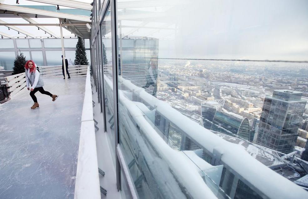 Visitors skate on the BMW Ice Rink 354 located on the 86th storey of the Moscow City OKO Tower. 