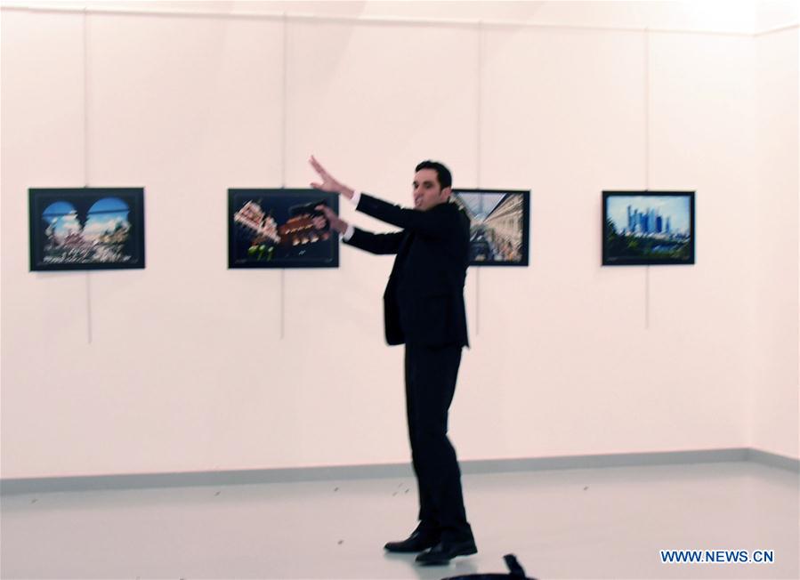 The gunman is seen at the shooting site of Russian Ambassador to Turkey Andrey Karlov in a modern art exhibition center in Ankara, Turkey, Dec. 19, 2016. The Russian Foreign Ministry confirmed that the country