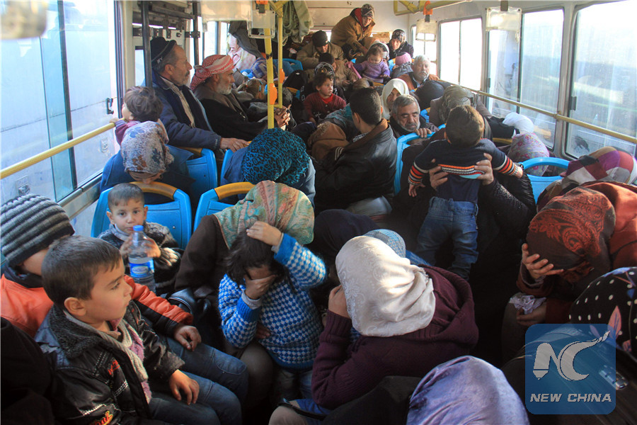 Residents from the mostly Shiite Syrian villages of Kafraya and Fuaa, which are besieged by opposition fighters, wait in a bus to get a green light from the rebels to cross into a government controlled area in the province of Aleppo, on December 20, 2016. (AFP/Xinhua)