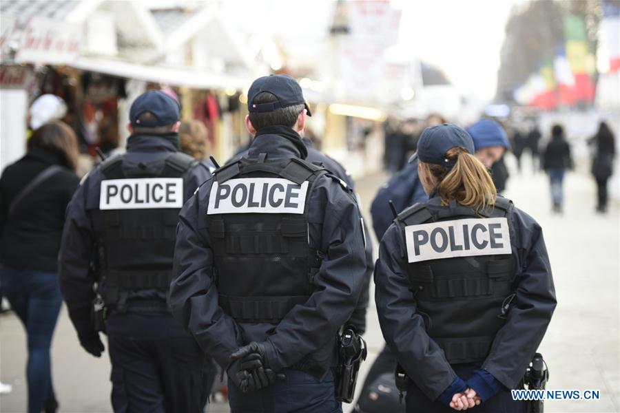 Police officers patrol at a Christmas market along the Champs-Elysees in Paris, capital of France, on Dec. 20, 2016. French Interior Minister Bruno Le Roux on Monday decided to reinforce security at France