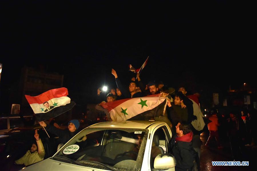 People celebrate the restoration of security and stability to all of Aleppo city in Aleppo, northern Syria, on Dec. 22, 2016. The Syrian army declared on Thursday the liberation of eastern Aleppo city in northern Syria, as the last batch of rebels left the city, making Aleppo city completely under the government control. (Xinhua/Yang Zhen) 