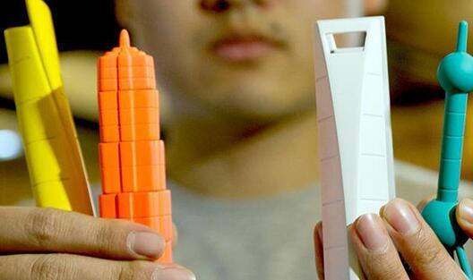 a pen shaped like the Oriental Pearl TV Tower, a pen that looks like Shanghai World Financial Center, a pencil sharpener that looks like Shanghai Tower, and a set of 5 magnets that look like Jinmao Tower.