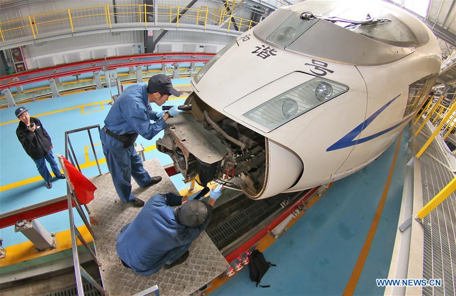 Mechanics check a bullet train in Qingdao City, east China