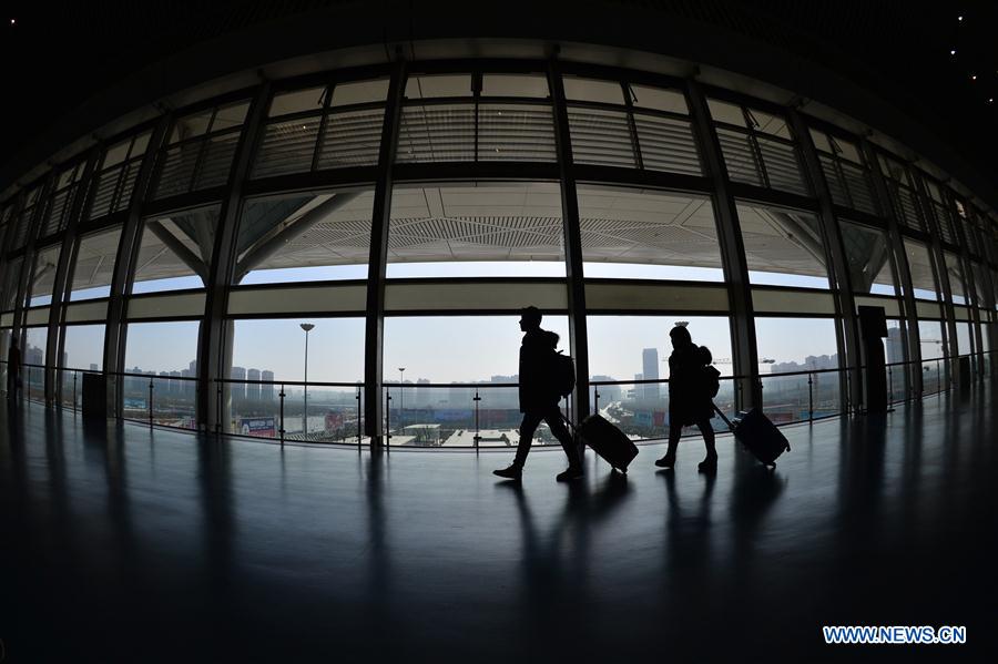 Passengers prepare to get on bullet trains in Xi