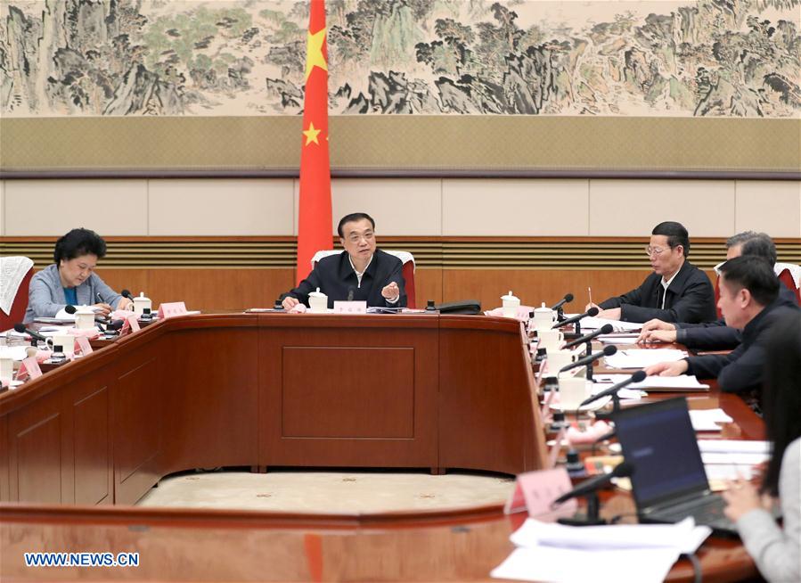 Chinese Premier Li Keqiang (back, C) presides over a symposium to solicit opinions from experts and entrepreneurs on the draft of an annual government work report in Beijing, capital of China, Jan. 13, 2017. Chinese Vice Premier Zhang Gaoli attended the symposium. (Xinhua/Ma Zhancheng)