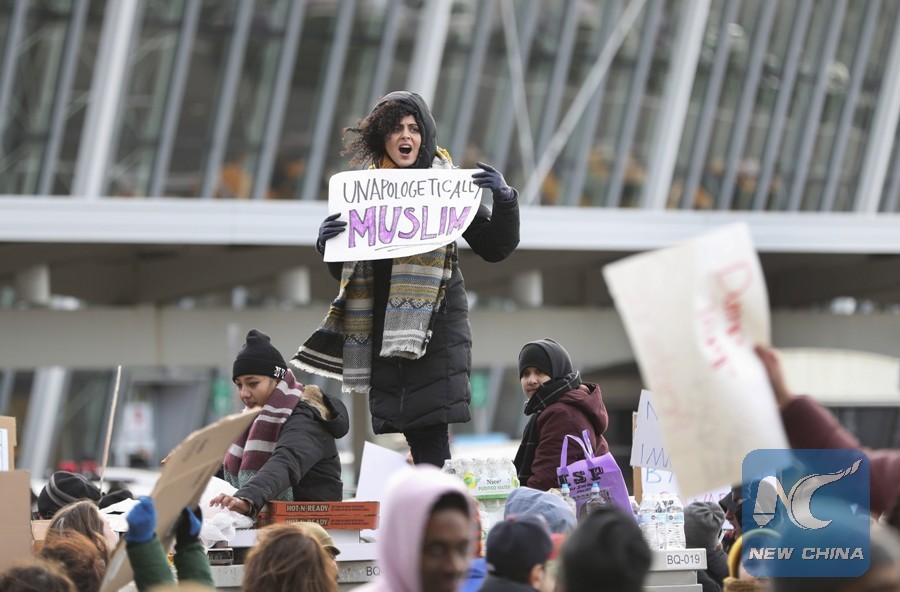 The file photo taken on Jan. 29, 2017 showed that People hold posters during a protest against President Donald Trump