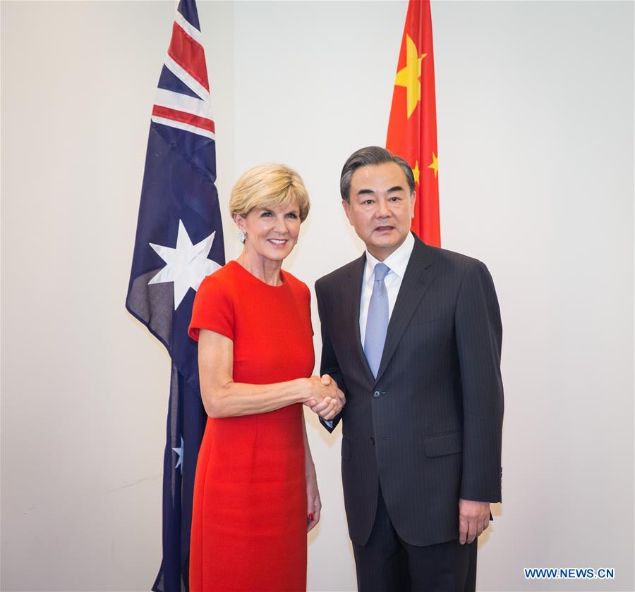 Chinese Foreign Minister Wang Yi (R) shakes hands with his Australian counterpart Julie Bishop prior to the two countries