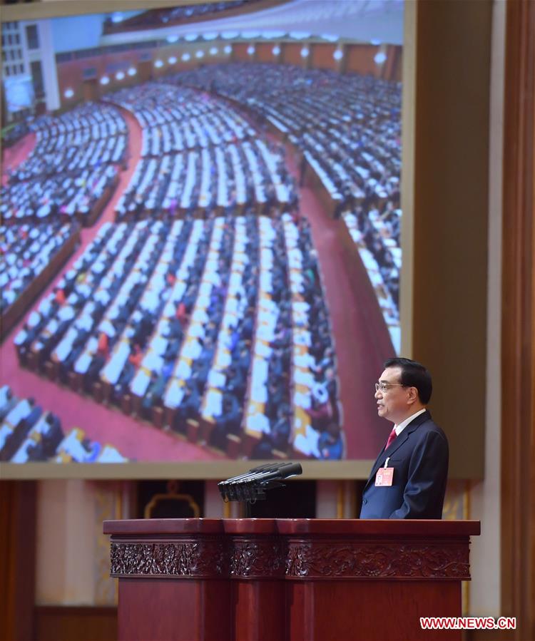 Chinese Premier Li Keqiang delivers a government work report during the opening meeting of the fifth session of China