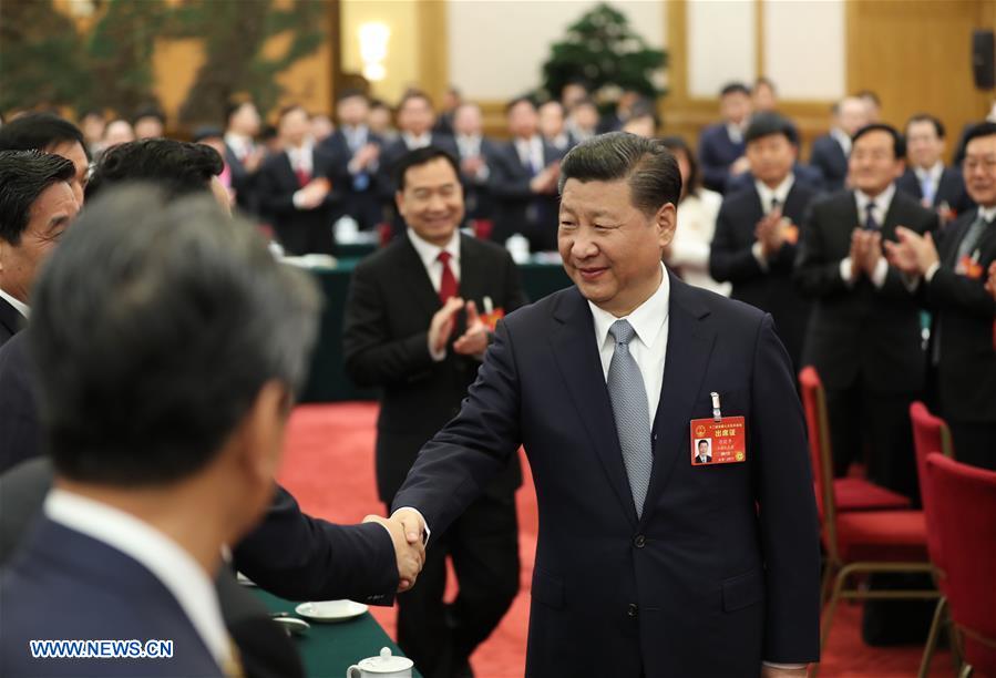 Chinese President Xi Jinping joins a panel discussion with deputies to the 12th National People