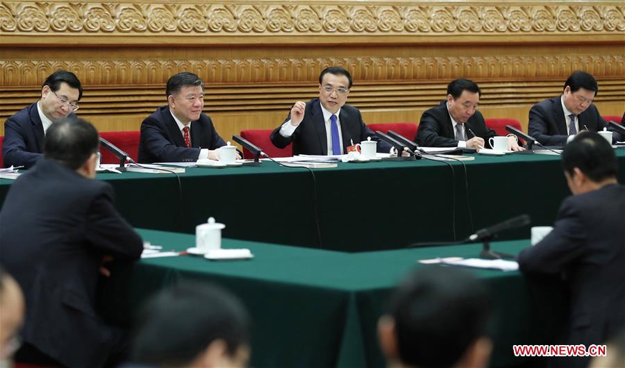 Chinese Premier Li Keqiang joins a panel discussion with deputies to the 12th National People