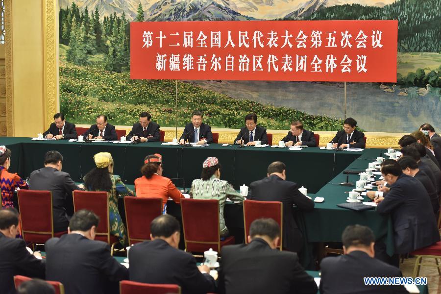 Chinese President Xi Jinping joins a panel discussion with deputies to the 12th National People