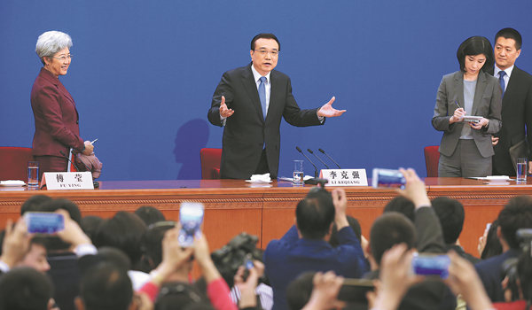 Premier Li Keqiang speaks to reporters at the conclusion of a news conference after the closing session of the National People