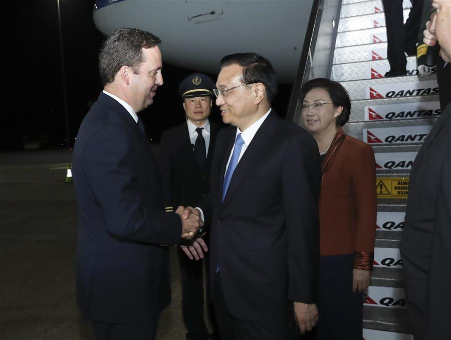 Chinese Premier Li Keqiang (3rd L) arrives with his wife Cheng Hong (4th L) in Canberra, Australia, March 22, 2017, for an official visit to Australia at the invitation of his Australian counterpart Malcolm Turnbull. Li and Turnbull will hold the fifth annual meeting of the two prime ministers. (Xinhua/Pang Xinglei)