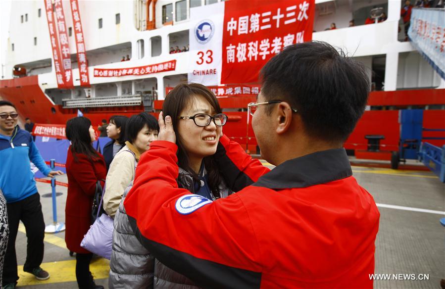 Zhang Nan (R), a member of the Chinese scientific expedition team, hugs his wife after returning to Shanghai, east China, April 11, 2017. Chinese scientists concluded a 161-day expedition, the 33rd of its kind, to Antarctica on the Xuelong icebreaker and returned to Shanghai on Tuesday. (Xinhua/Fang Zhe)   