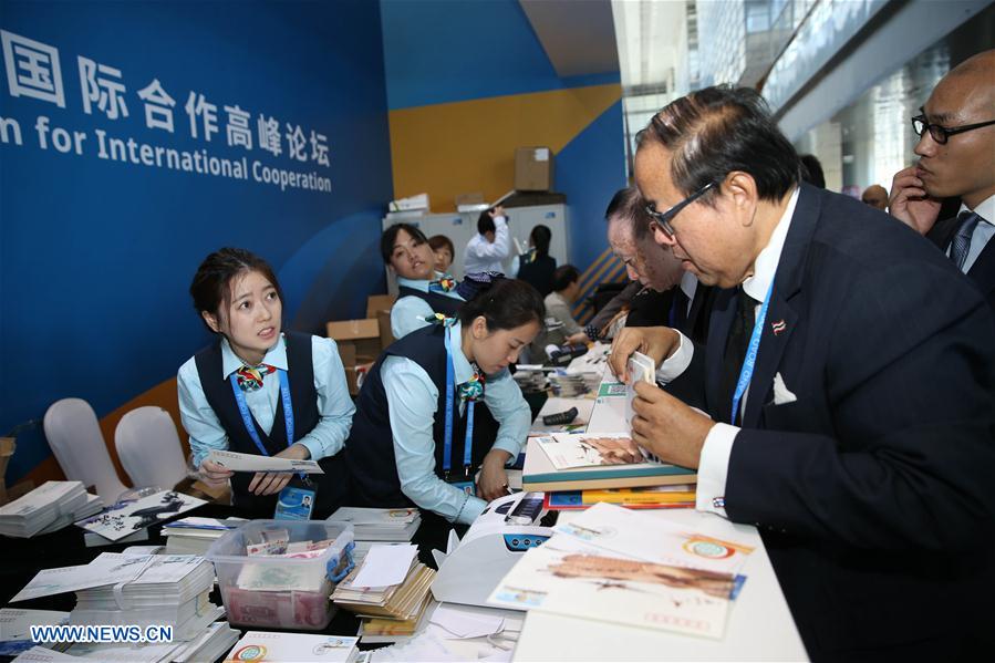 Staff members sell commemorative first-day covers featuring the Belt and Road Forum (BRF) for International Cooperation at the China National Convention Center in Beijing, capital of China, May 14, 2017.The Belt and Road Forum (BRF) for International Cooperation opened in Beijing on Sunday. (Xinhua/Cai Yang)