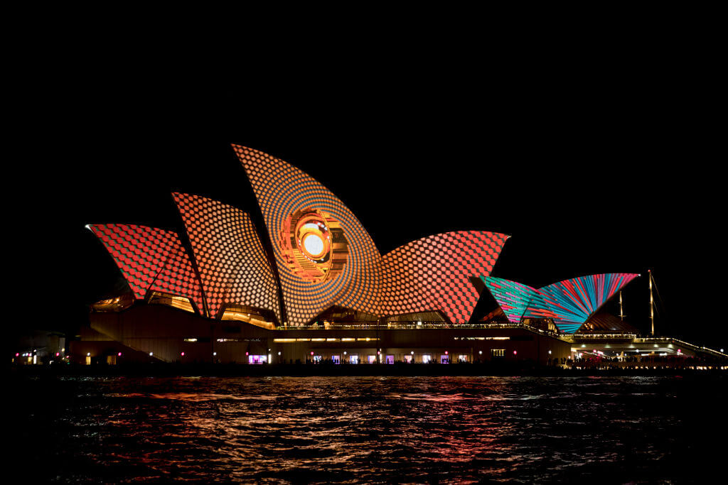 The sails of the Opera House are lit to start the Vivid Festival.