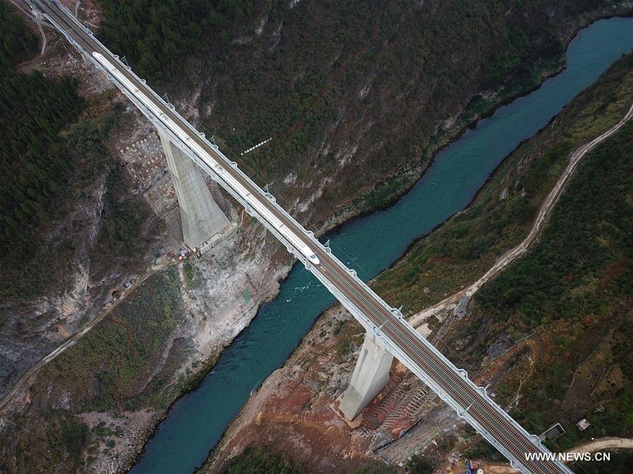 A bullet train runs through a bridge over Wujiang River, a tributary of China