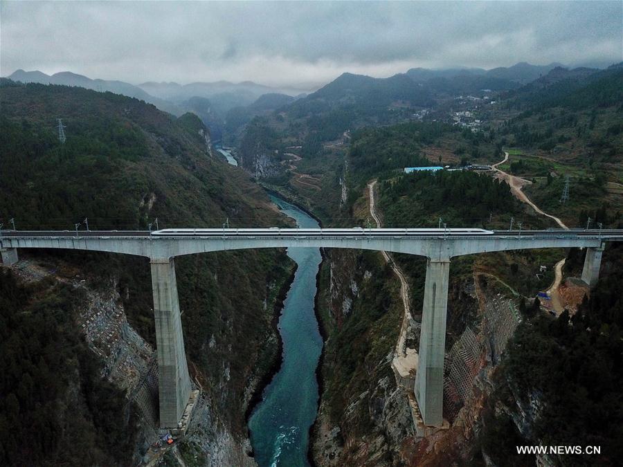 A bullet train runs through a bridge over Wujiang River, a tributary of China