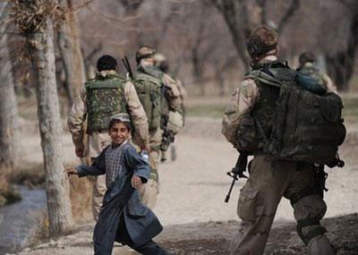 An Afghan boy looks back while Dutch soldiers patrol a village of Chora valley in the southern Afghan province of Uruzgan on January 21. (AFP/File/Deshakalyan Chowdhury)