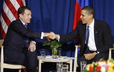 U.S. President Barack Obama (R) shakes hands with his Russian counterpart Dmitry Medvedev at the Bella Center in Copenhagen December 18, 2009. The United States and Russia are "quite close" to agreeing a new START nuclear arms reduction pact, Obama said on Friday. REUTERS/Larry Downing