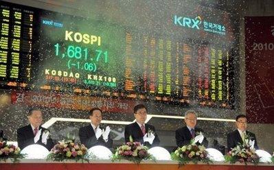 South Korea's Financial Services Commission chairman Chin Dong-Soo (centre) and officers celebrate during the New Year's opening of the stock market at the Korea Exchange in Seoul on January 4. Asian markets began the new decade broadly higher Monday with dealers in Tokyo lifted by news of extended credit to Japan Airlines and a strong yen as well as upbeat jobs data in the United States.(AFP/Jung Yeon-Je) 