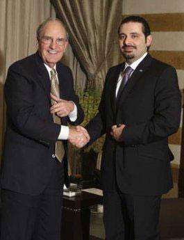 Lebanon's Prime Minister Saad al-Hariri (R) shakes hands with George Mitchell, the U.S. special envoy to the Middle East, during their meeting in Beirut, January 19, 2010. REUTERS/Mohamed Azakir