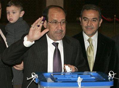 Iraqi Prime Minister Nouri al-Maliki holds up an ink-marked finger as he casts his ballot in the Iraqi parliamentary election at a polling station in the Green Zone in Baghdad, Iraq Sunday March 7, 2010. (AP Photo/Ali Abbas, Pool)