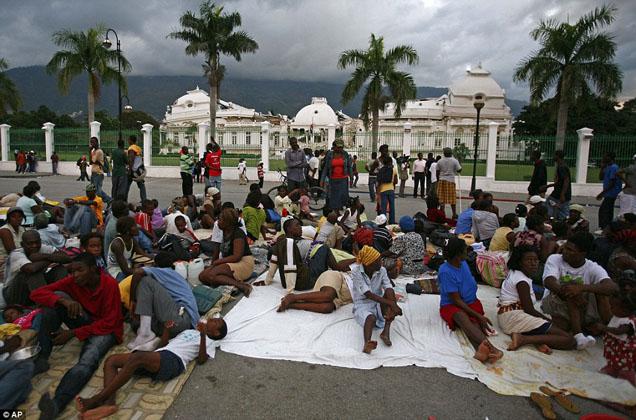 Desperate: Survivors gather outside the ruins of Haiti鈥檚 National Palace in the earthquake ravaged city of Port-au-Prince

