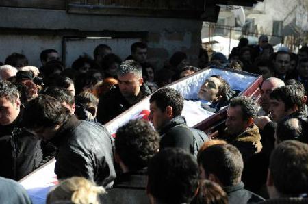 People carry the coffin of Georgian luge competitor Nodar Kumaritashvili during a funeral in Bakuriani, some 160 km (100 miles) west of Tbilisi, Feb. 20, 2010. Kumaritashvili was killed in a horrific training crash during the final luge session for the Vancouver 2010 Winter Olympics at the Whistler Sliding Centre on Feb. 12, 2010. (Xinhua/Liu Lihang)