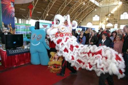 People visit the picture exhibition featuring The 2010 Shanghai World Expo in Ottawa, Canada, March 7, 2010. The exhibition is organized by Chinese National Tourism Administration with the theme of The 2010 Shanghai World Expo. (Xinhua/Zhang Dacheng)