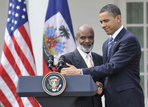 U.S. President Barack Obama (R) shakes hands with visiting Haitian President Rene Preval while meeting the media after their talks at the Rose Garden of the White House in Washington D.C., capital of the United States, March 10, 2010. (Xinhua/Zhang Jun)