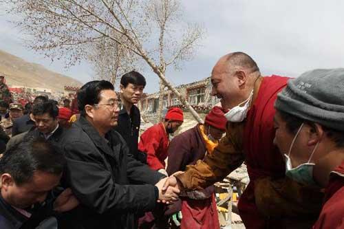 Chinese President Hu Jintao shakes hands with a local resident in the Tibetan Autonomous Prefecture of Yushu, northwest China's Qinghai Province, April 18, 2010. Hu arrived in Yushu Sunday morning to direct relief work. (Xinhua/Lan Hongguang)