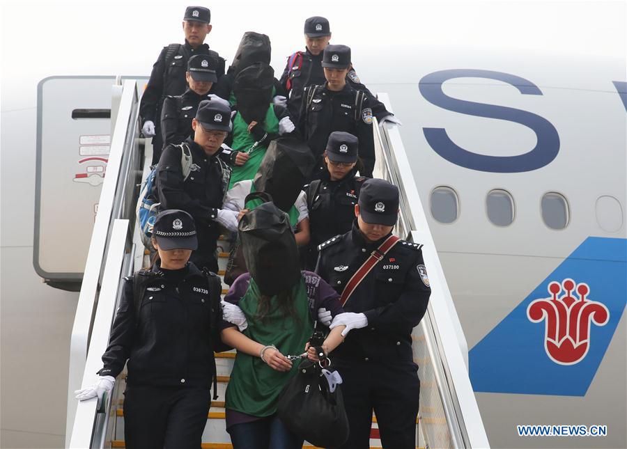 BEIJING, April 13, 2016 (Xinhua) -- Chinese telecom fraud suspects deported from Kenya get off a plane after arriving at the Beijing Capital International Airport in Beijing, capital of China, April 13, 2016. Kenyan police deported 77 Chinese telecom fraud suspects, including 45 Taiwanese, to the Chinese mainland. The first group of 10 people had been repatriated on Saturday and the remaining 67 were sent back by a chartered plane on Wednesday. (Xinhua/Yin Gang)