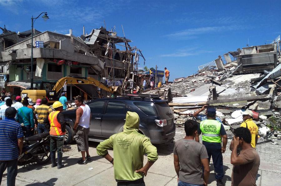 Residents stand in front of the debris of houses after an earthquake in the city of Chone, Manabi Province, Ecuador, on April 17, 2016. The strongest earthquake to jolt Ecuador in decades has killed 233 people, the country