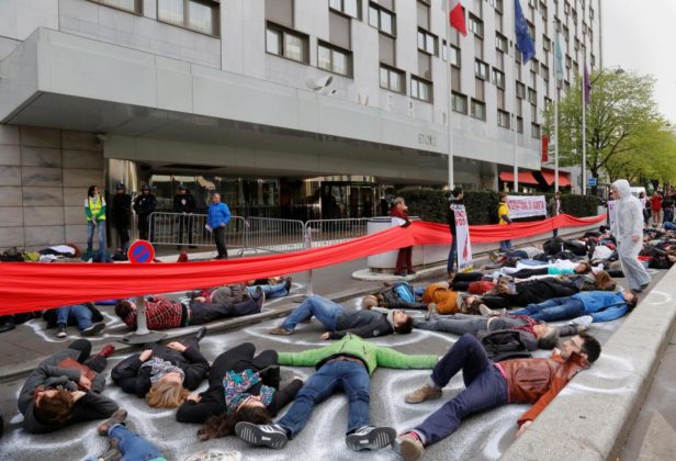 Dozens of climate activists have gathered outside the Paris hotel venue of the International Oil Summit, protesting against industry practices that could hamper the new climate accord.