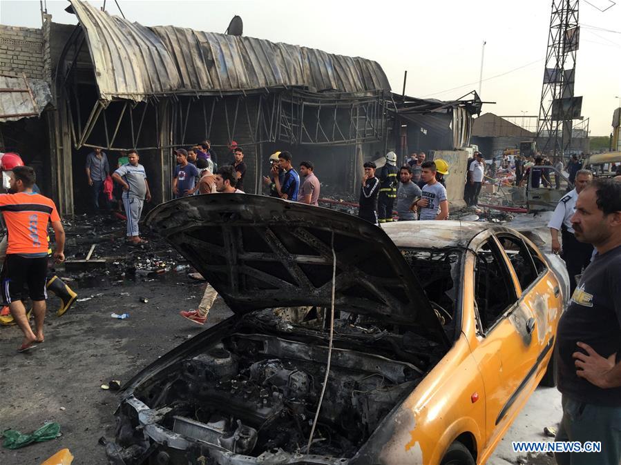 People gather at the site where a car bomb exploded at a marketplace in Baghdad, Iraq, on April 25, 2016. The car bomb attack left at least seven civilians killed and some 30 others wounded. (Xinhua/Khalil Dawood) 