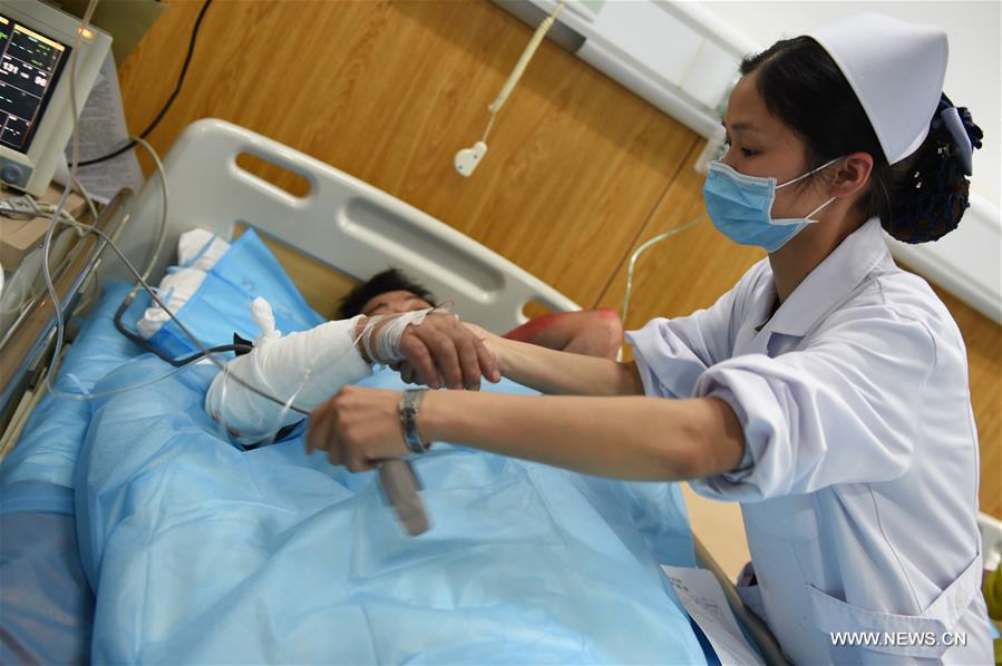  A man injured during a landslide accident receives medical treatment at the county hospital of Taining, southeast China