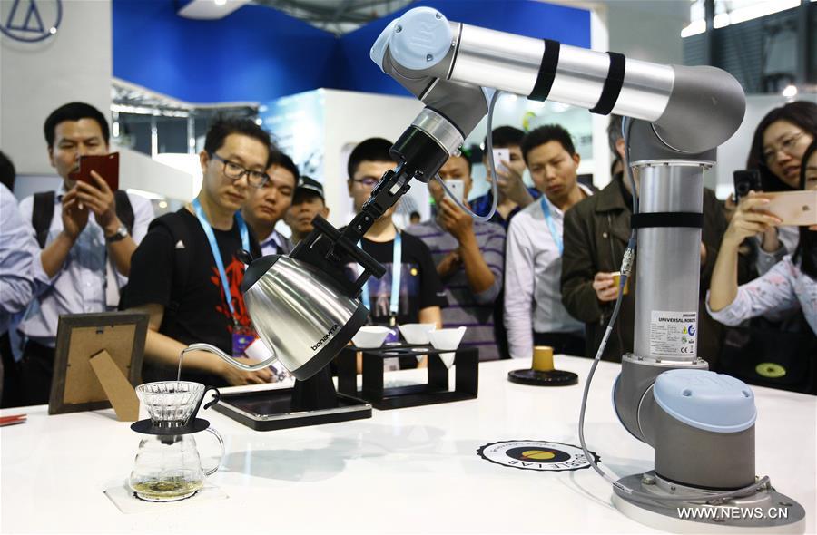 SHANGHAI, May 11, 2016 (Xinhua) -- A robot performs serving tea during CES Asia 2016 in Shanghai, east China, May 11, 2016. The CES Asia 2016, with the participation of over 3,200 enterprises from over 150 countries, kicked off here Wednesday. (Xinhua/Fang Zhe)