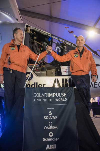 The file photo shows the two pilots of the Swiss-made Solar Impulse 2 in front of the airplane. 